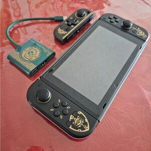 Nintendo Handheld Console with Black and Gold Design
